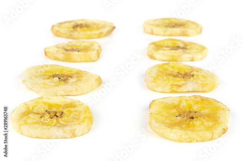 Group of eight slices of sweet yellow dry banana isolated on white background
