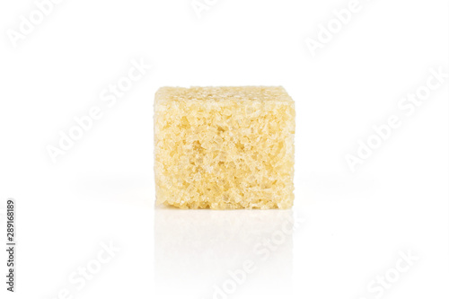One whole sweet brown sugar cube isolated on white background