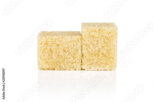 Group of two whole sweet brown sugar cube isolated on white background