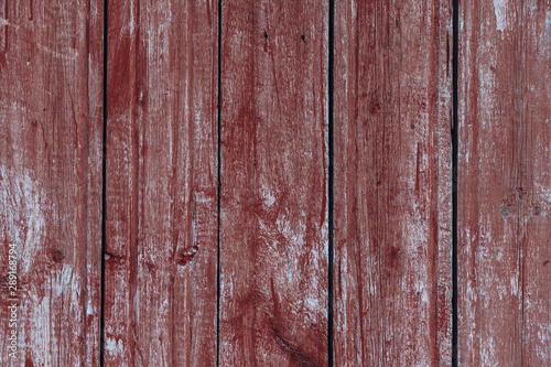 Red wood background. Wall of red house made of planks, photo background