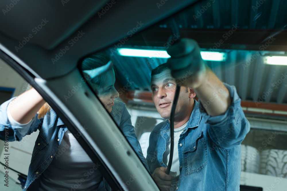 mechanic changing glass on car in his workshop mechanic changing glass on car in his workshop