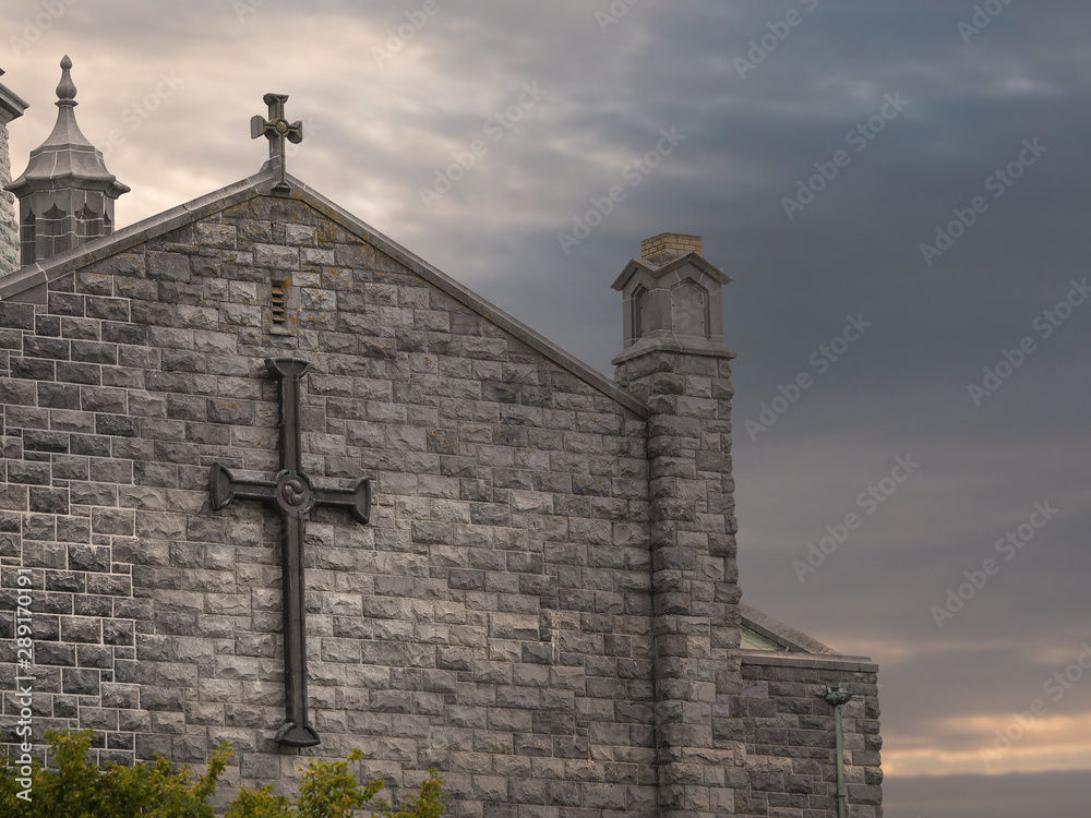 Part of Galway Cathedral, Wall and roodf with crosses, Calm and peaceful sunset sky.