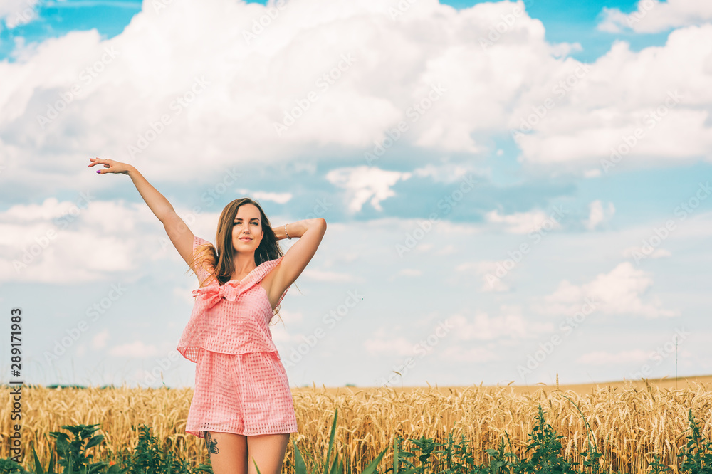 Summer portrait of happy young woman posing in wheat field Summer portrait of happy young woman posing in wheat field
