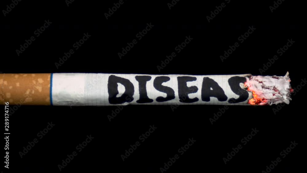 A cigarette smolders with the word A cigarette smolders with the word