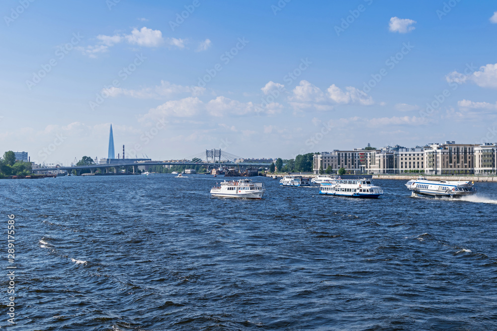 Little Neva River with sightseeing boats and two hydrofoils and Betancourt Bridge  in Saint Petersburg, Russia