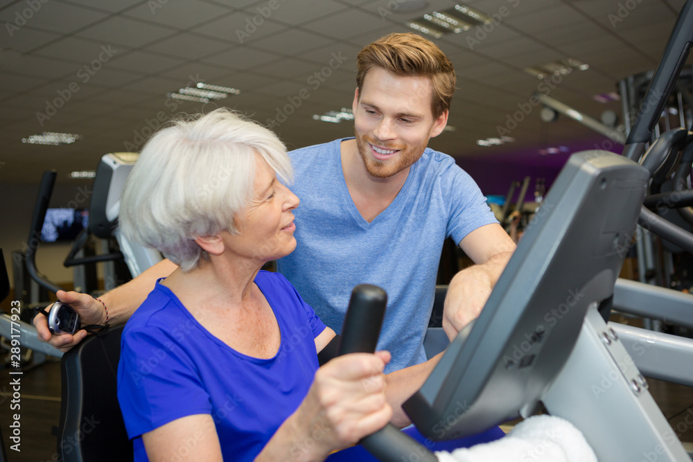 healthy elderly woman training with personal trainer healthy elderly woman training with personal trainer