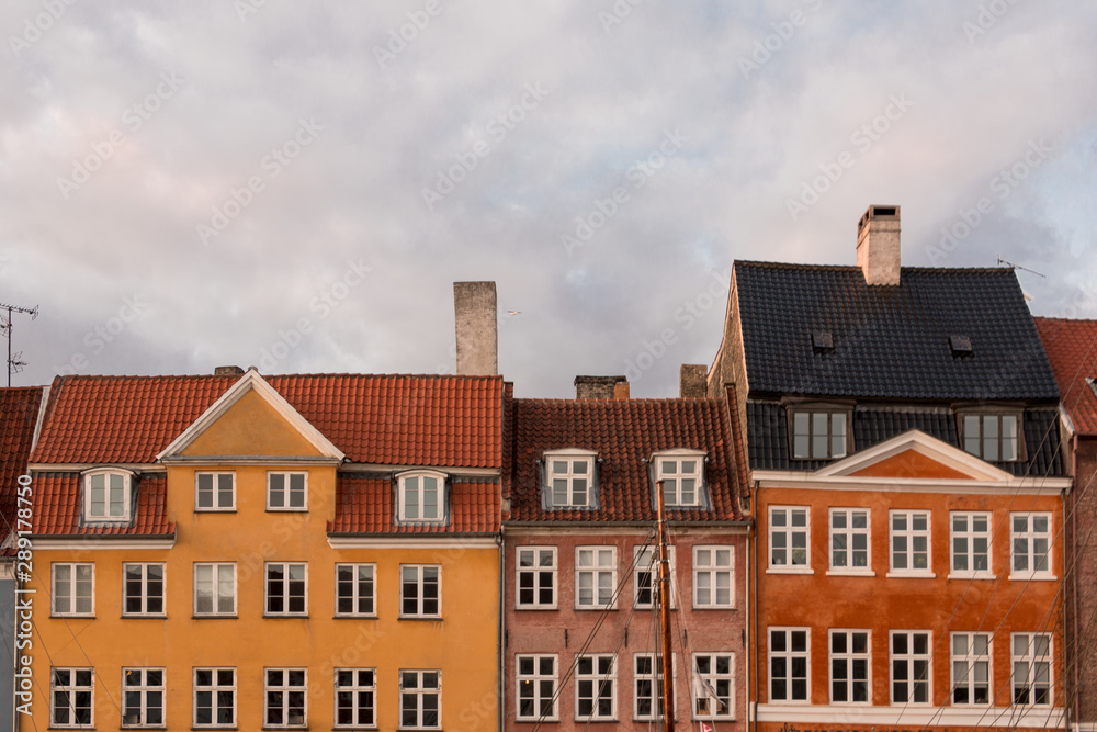 Partial view of the colorful facades of the typical houses in front of the Nyhavn canal in Copenhagen.