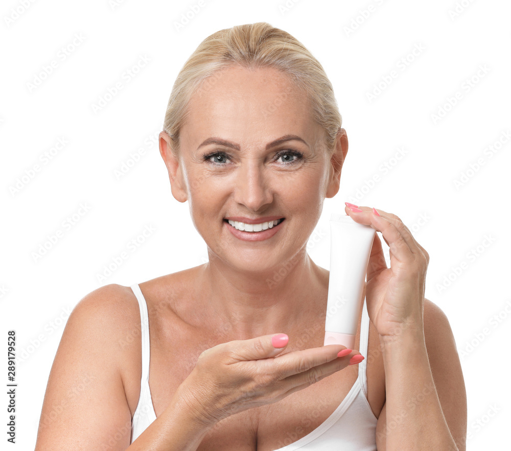 Portrait of beautiful mature woman with perfect skin holding tube of cream  on white background Photos | Adobe Stock
