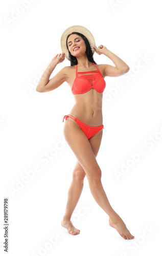 Beautiful young woman in stylish bikini with hat on white background