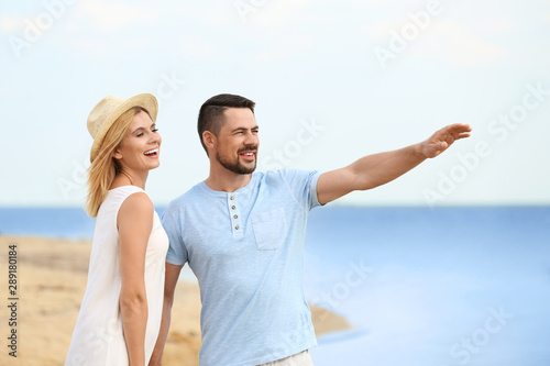 Happy romantic couple spending time together on beach