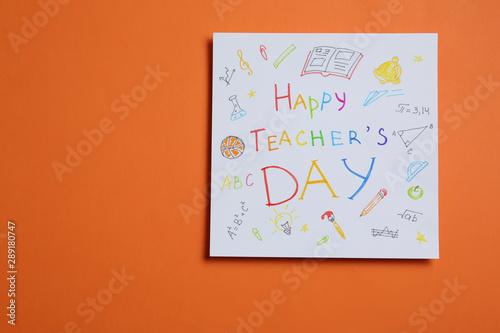 Paper with inscription HAPPY TEACHER S DAY on orange background  top view. Space for text