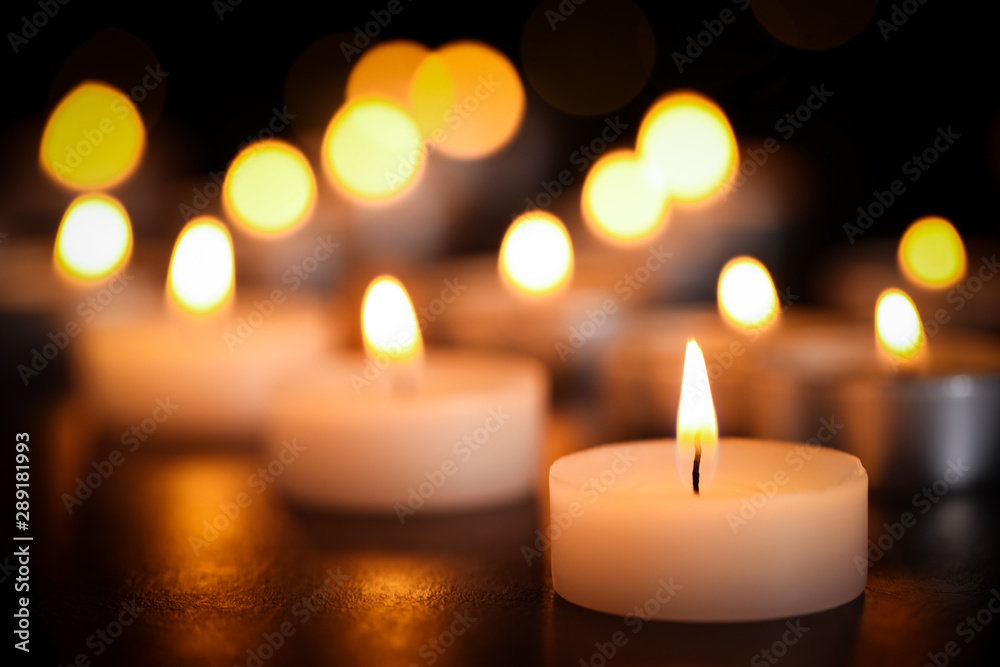 Burning candles on table, closeup. Funeral symbol Burning candles on table, closeup. Funeral symbol