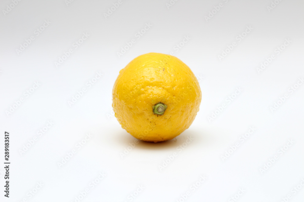 Fresh, ripe, isolated, juicy single lemon on a white background. Studio macro shoot Fresh, ripe, isolated, juicy single lemon on a white background. Studio macro shoot