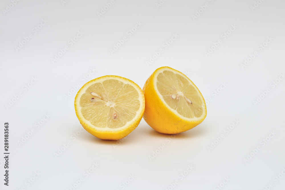 Fresh, ripe, isolated, juicy bisected lemon on a white background. Studio macro shoot Fresh, ripe, isolated, juicy bisected lemon on a white background. Studio macro shoot