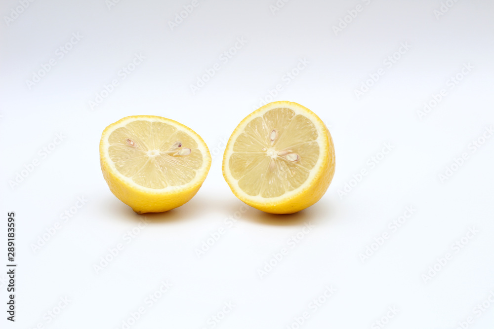 Fresh, ripe, isolated, juicy bisected lemon on a white background. Studio macro shoot Fresh, ripe, isolated, juicy bisected lemon on a white background. Studio macro shoot