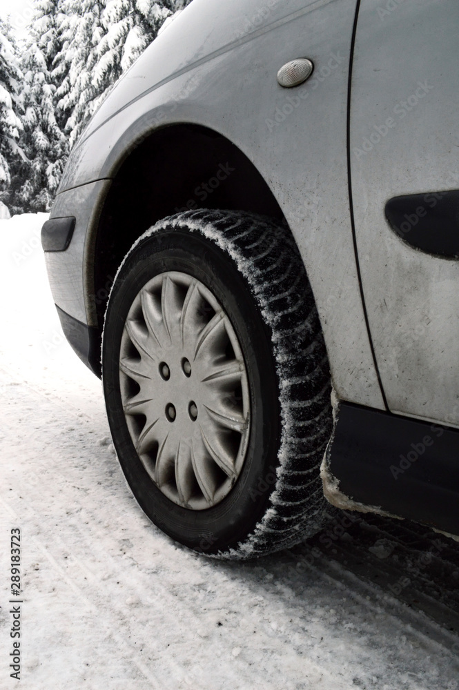 A car equipped with snow tires, on a dangerous road and snowy mountain during the winter. Snow tires keep driving safely on the snow.