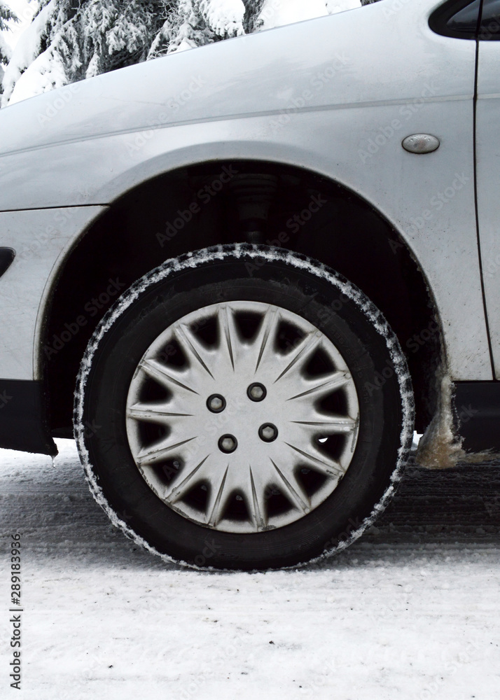 A car equipped with snow tires, on a dangerous road and snowy mountain during the winter. Snow tires keep driving safely on the snow.