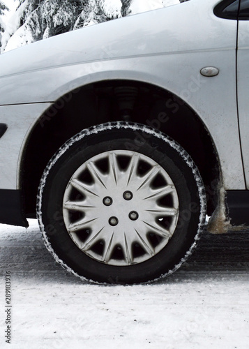 A car equipped with snow tires, on a dangerous road and snowy mountain during the winter. Snow tires keep driving safely on the snow. © jpr03