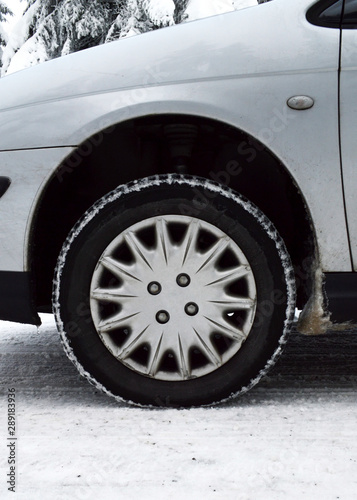 A car equipped with snow tires, on a dangerous road and snowy mountain during the winter. Snow tires keep driving safely on the snow.