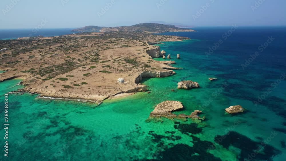 Aerial drone video of paradise island of Kato Koufonisi with numerous secluded rocky beaches with emerald clear sea, Small Cyclades, Greece 