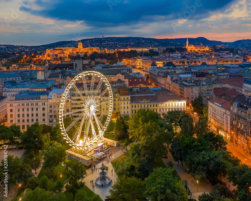 Budapest eye ferris wheel with buda castle and fisherman's bastion in the background © GezaKurkaPhotos