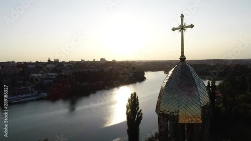 VINNITSA, UKRAINE -  June 16, 2019:  River,cross, church, sunset.