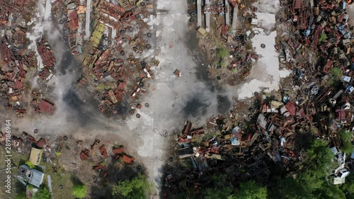 Aerial view of radioactive iron trash on scrap dump in Chernobyl exclusion zone. Drone shot of wrecked rusty metal skeletons of machinery used in liquidation of accident at nuclear power plant