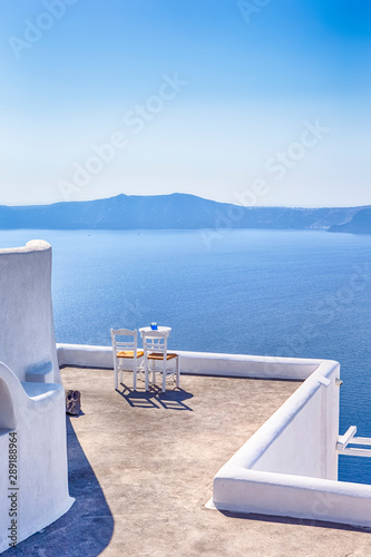 Pair of White Chairs on The Edge of The Roof in Thira City of Santorini.