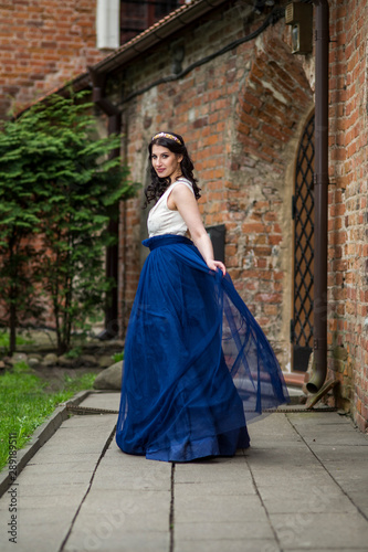 Portrait of Sensual Young Brunette Lady Dancing in Long Blue Dress. Wearing Tiara. © danmorgan12