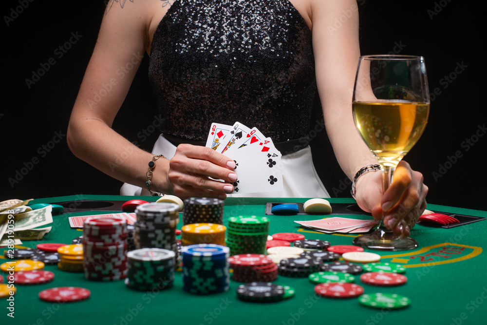 A woman plays in a casino. shows a winning combination on cards. Winning poker