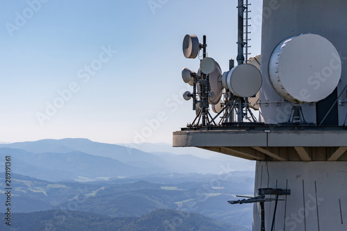 Directional radio antennas on a radio tower over the mountain peaks of the Black Forest, Germany