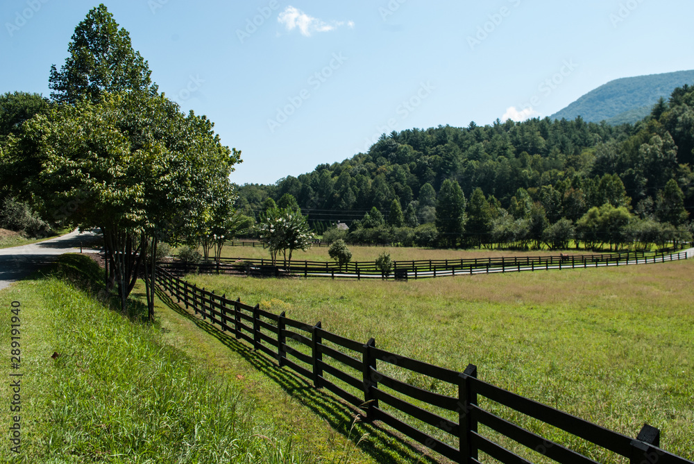 A shot of the stunning Georgia landscape. Fields, mountains and trees under a blue sky