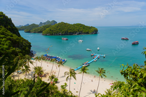 Tourist on the beach,Tropical group of islands and lot of speed boat and tourist boat floating on a blue turquoise ocean in Ang Thong National Marine Park in the Gulf of Thailand. Surat Thani Thailand