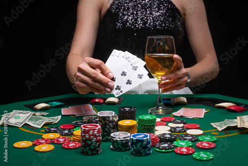 A woman plays in a casino. shows a winning combination on cards. Winning poker