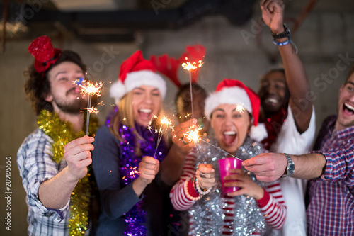 multiethnic group of casual business people lighting a sparkler