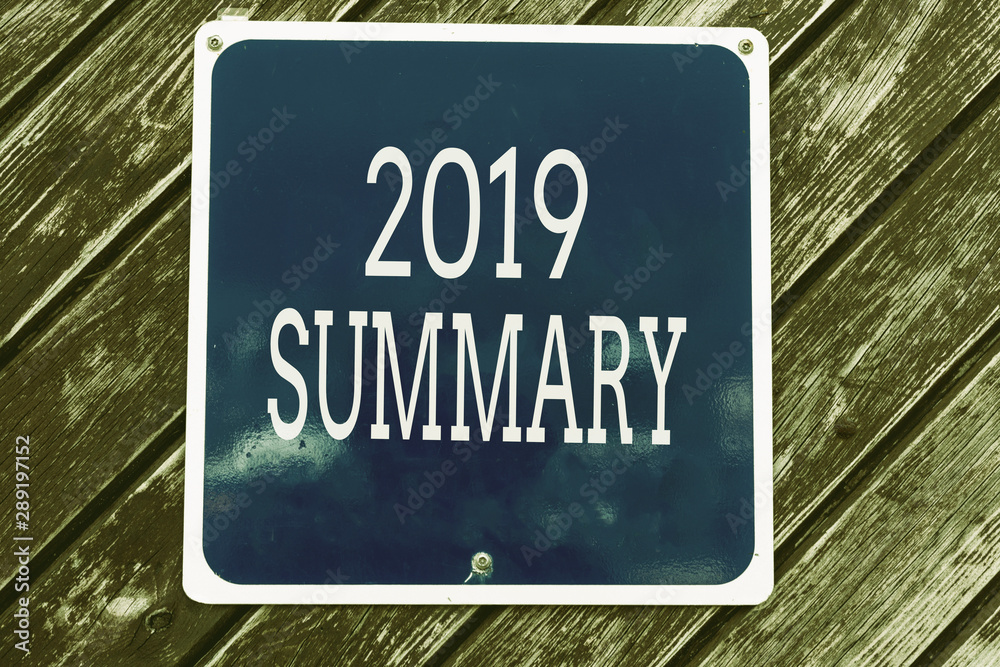 Obraz premium Handwriting text writing 2019 Summary. Conceptual photo brief comprehensive especially covering the main points of 2019 Empty blue board with copy space above wooden background