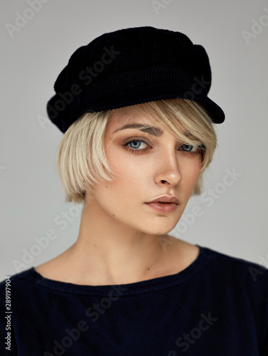 Beauty portrait of fashion young model with short hair and black cap © kiuikson