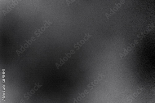 Brushed black metallic plate with scratched surface, abstract texture background