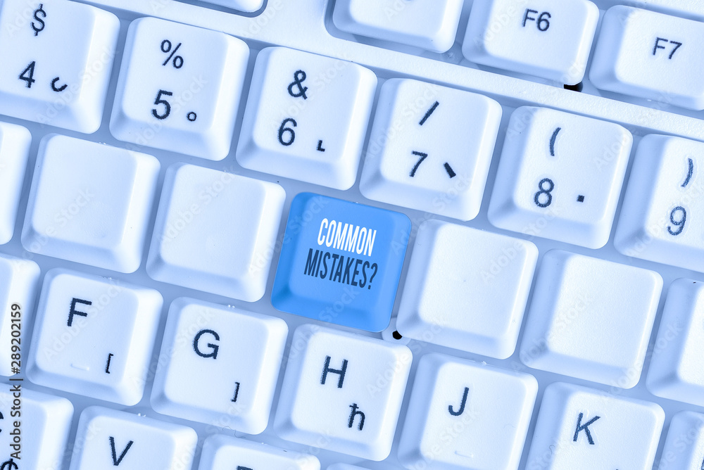 Writing note showing Common Mistakes Question. Business concept for repeat act or judgement misguided making something wrong White pc keyboard with note paper above the white background Writing note showing Common Mistakes Question. Business concept for repeat act or judgement misguided making something wrong White pc keyboard with note paper above the white background
