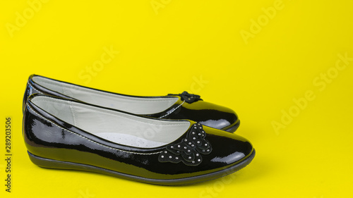 Leather leather shoes on bright yellow background.