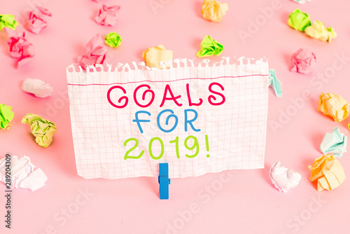 Conceptual hand writing showing Goals For 2019. Concept meaning object of demonstratings ambition or effort aim or desired result Colored crumpled papers empty reminder pink floor clothespin