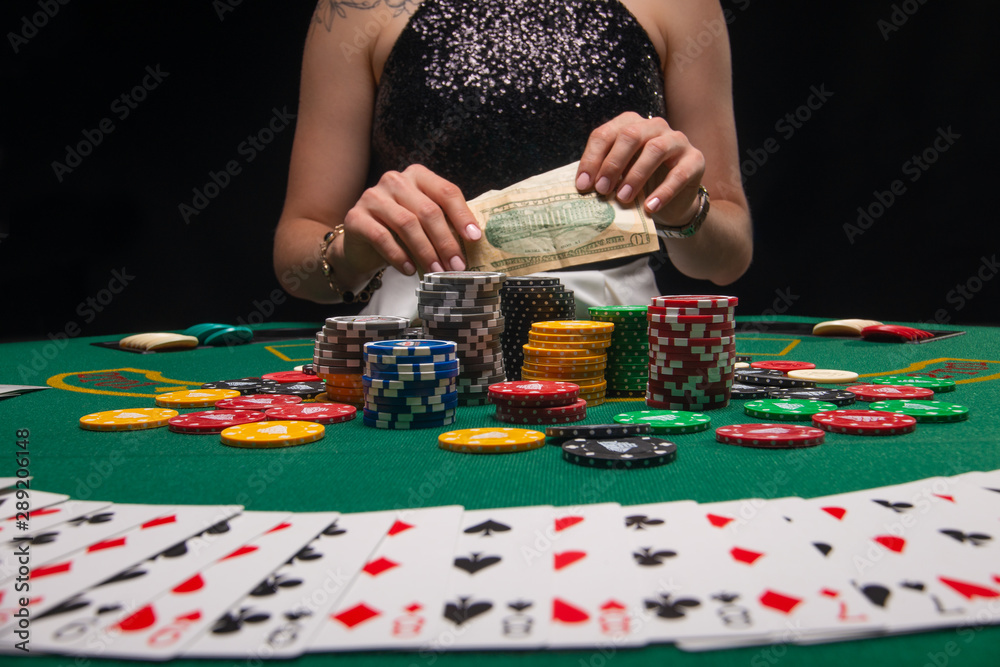 Background of a gaming casino, poker table, cards, chips and a girl with a glass of wine in the background. Background for a gaming business, success Background of a gaming casino, poker table, cards, chips and a girl with a glass of wine in the background. Background for a gaming business, success
