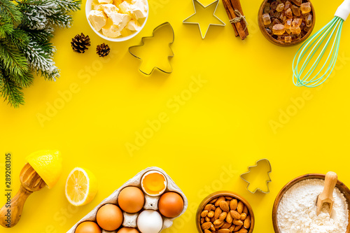 Kitchen frame. Dough ingredients and crockery on yellow background top view copy space