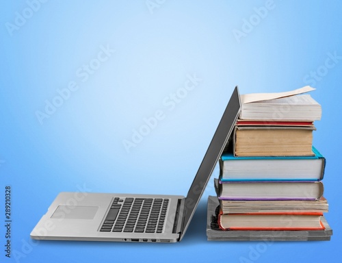 Stack of books with laptop on table © BillionPhotos.com