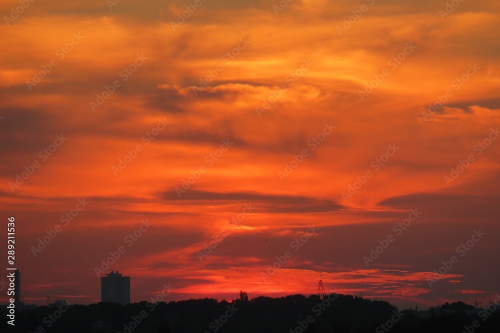 Beautiful fiery orange sunset over the city, natural background