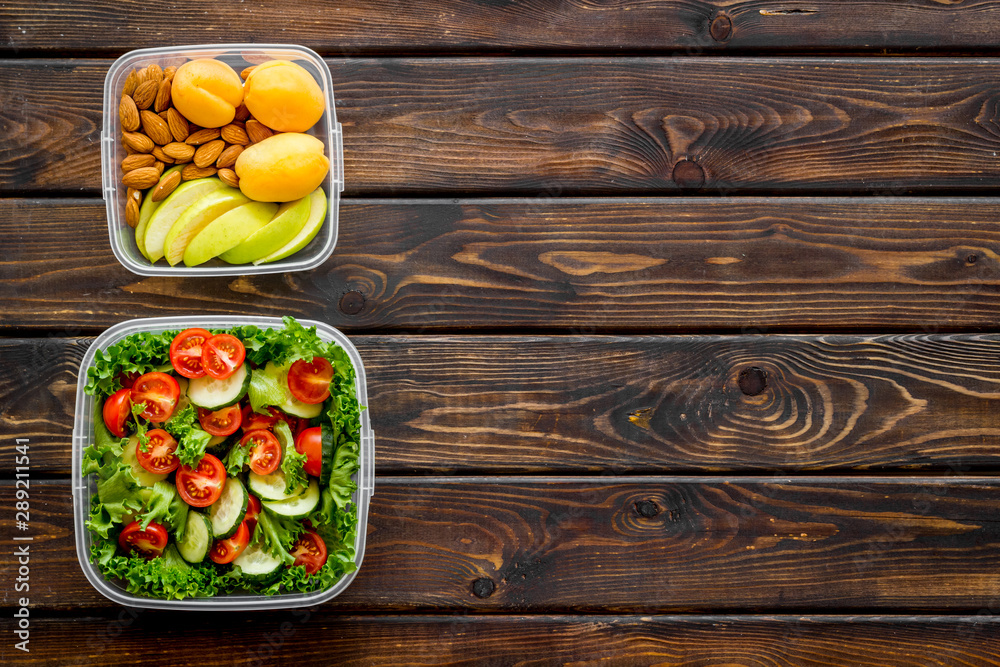 Lunch box for food to go with healthy meal on wooden background top view mock up Lunch box for food to go with healthy meal on wooden background top view mock up