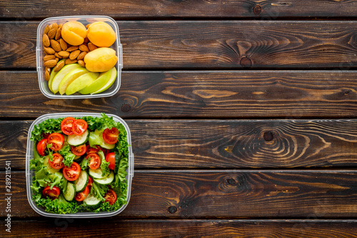 Lunch box for food to go with healthy meal on wooden background top view mock up