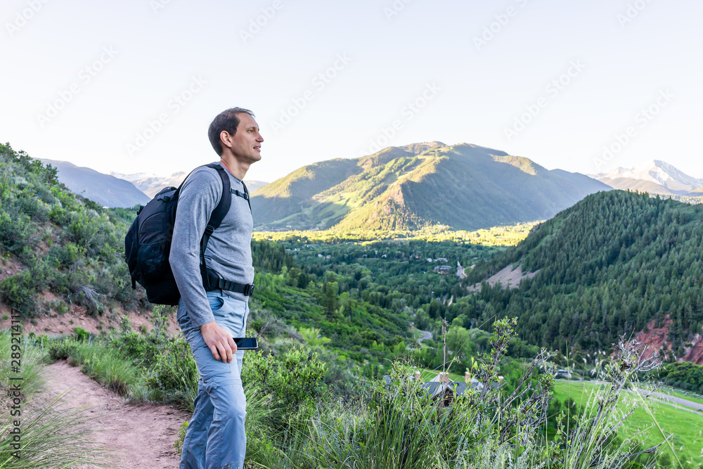 Sunnyside Trail and man standing hiking in Aspen, Colorado in Woody Creek neighborhood in early 2019 summer morning