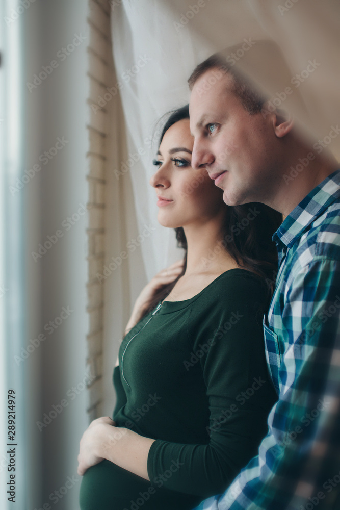 couple in love hugs. man and pregnant woman smiling. Valentine's day couple in love hugs. man and pregnant woman smiling. Valentine's day