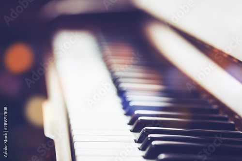 close up and selective focus on old piano keys with window light , music background